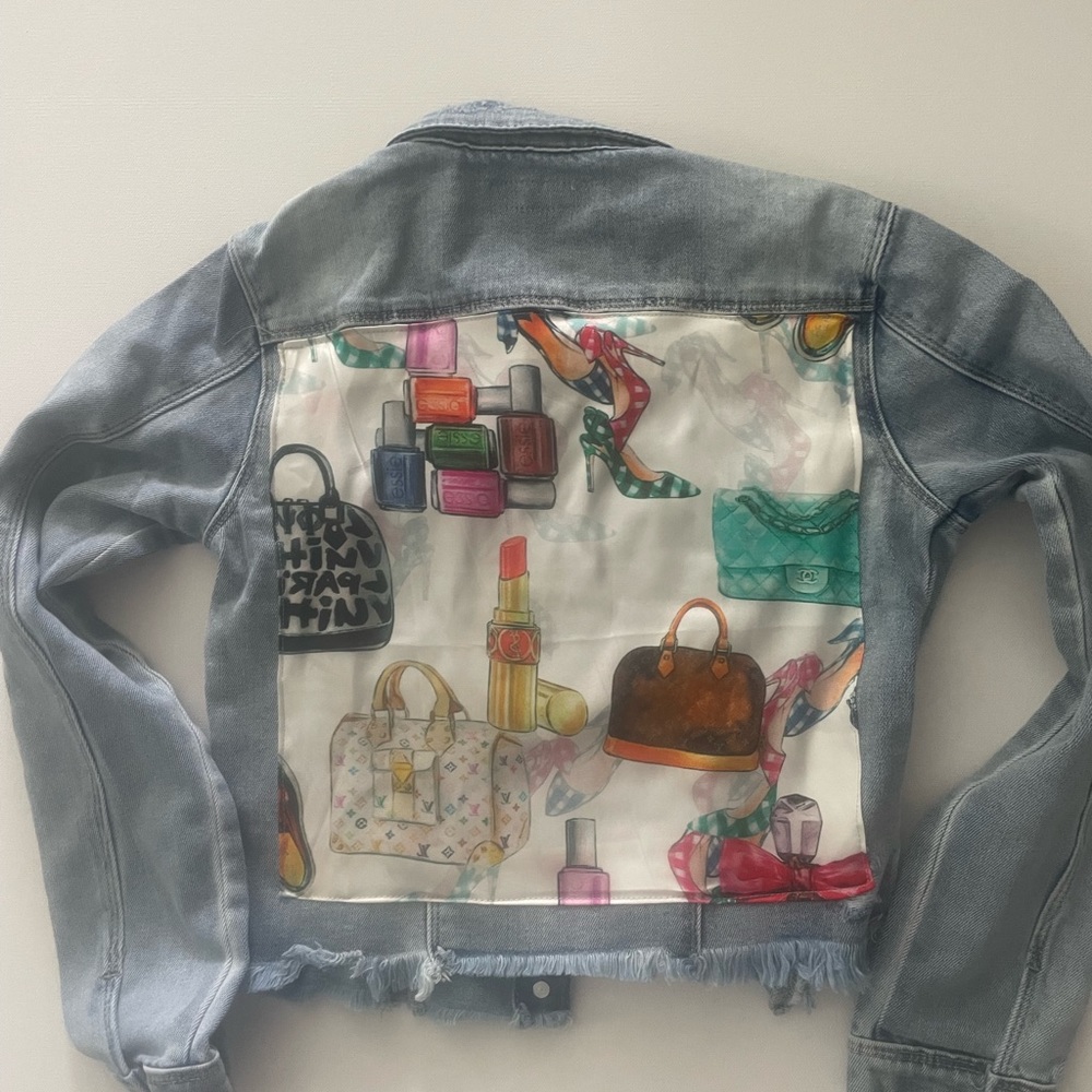 Denim jacket with scarf on back.